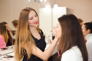 Student practicing makeup application