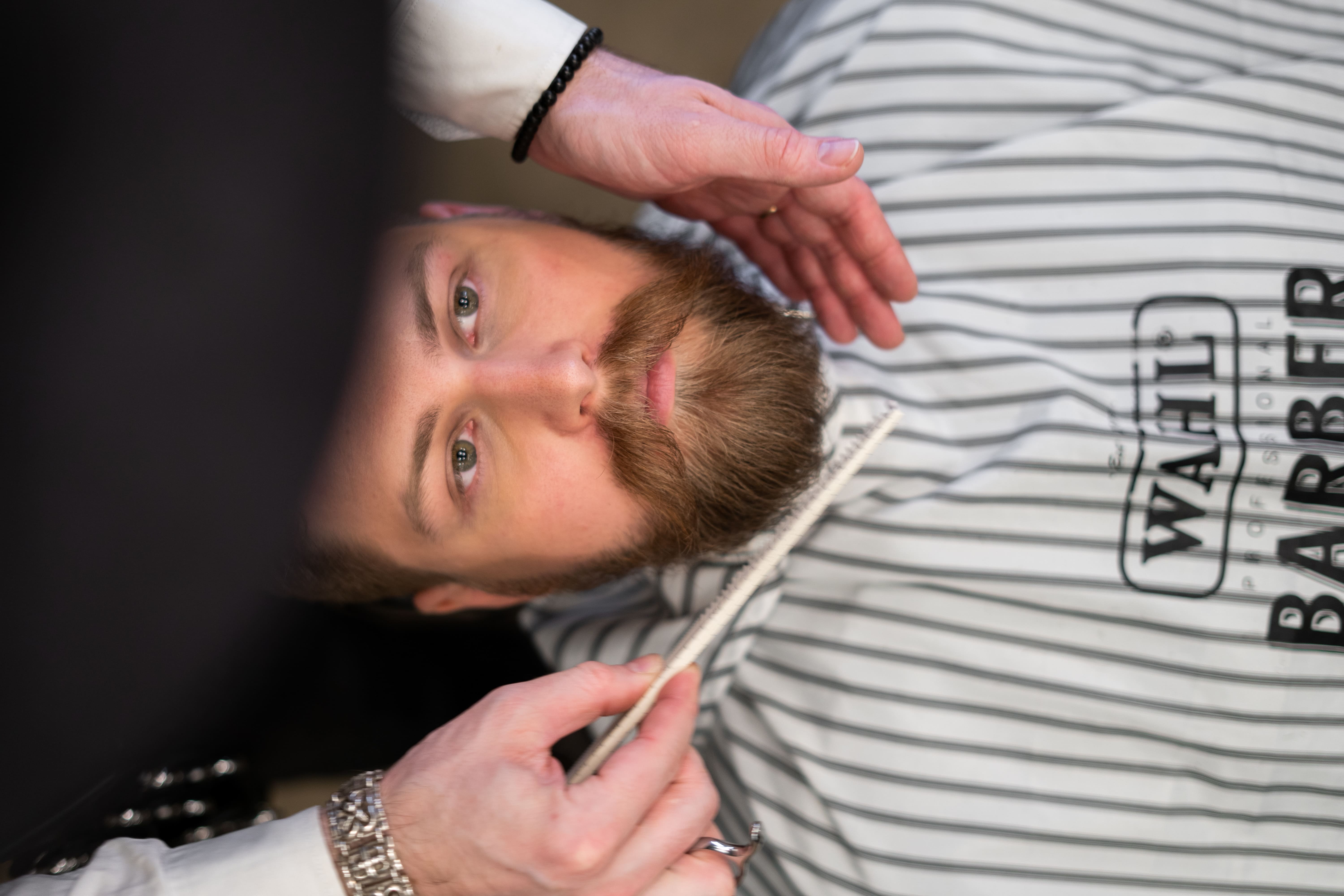 Barber using a Wahl branded cape