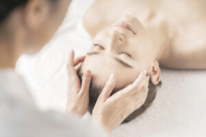 esthetician services provided to a young woman lying on a table