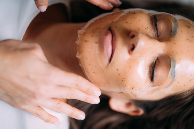 Woman receiving facial treatment in a cosmetology salon.