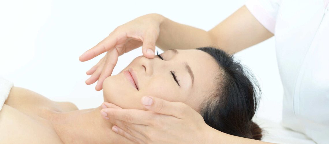 Esthetician performing facial treatment on client in Idaho.