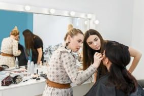 Makeup artist training session at Austin Kade Academy with students practicing techniques in east idaho