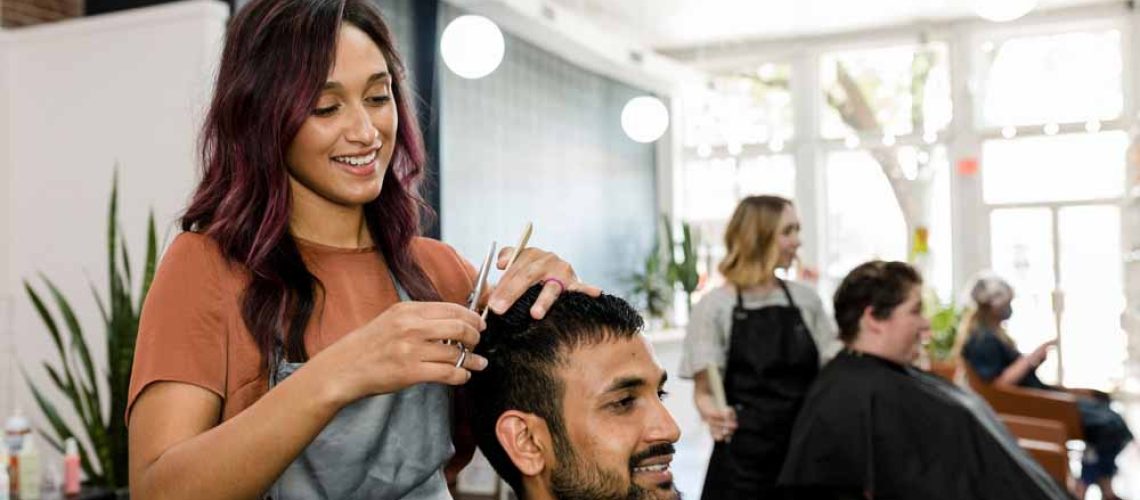 woman styling hair at east idaho salon