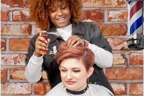 Barber student practicing haircutting techniques on a client at Austin Kade Academy in idaho falls